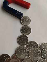 Coins are attracted by the action of a magnet.