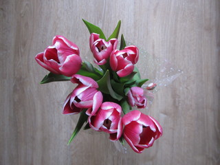 Bouquet of blooming tulips on a wooden background.