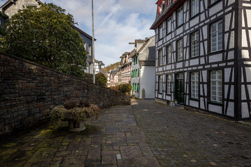 Paved narrow road with half-timbered houses in Monschau, Eifel