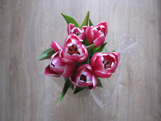 Bouquet of blooming tulips on a wooden background.