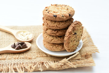 Oatmeal cookies and chocolate chips on cloth background