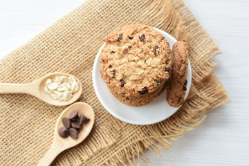 Oatmeal cookies and chocolate chips on cloth background