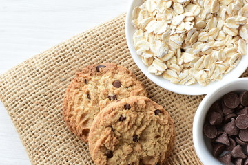 Oatmeal cookies and chocolate chips on cloth background
