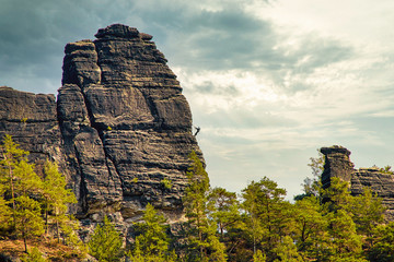 Sandstone rock formation the locomotive in German-Saxon Switzerland with climbers on the right