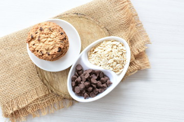 Oatmeal cookies and chocolate chips on cloth background