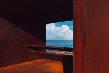 Fototapeta premium A viewpoint next to the Mediterranean sea overlooking the sea with rocks and a large cloud the background with the blue sky