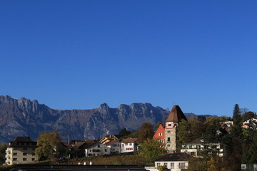 Fototapeta na wymiar A view of Vaduz (the capital city of Liechtenstein in Europe) and Swiss Alps, taken from Vaduz Castle trail.