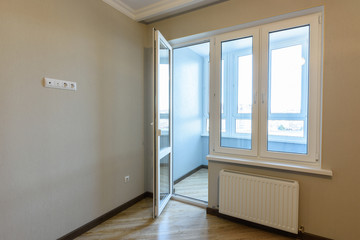 Exit to the balcony in an empty apartment after repairs