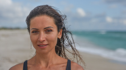 Fototapeta na wymiar dark-haired girl on the beach portrait