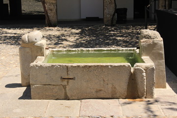 An old fountain with a small pool in Granada, Andalusia, Southern Spain.