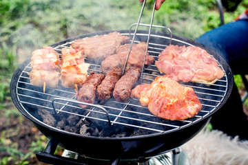 Closeup of barbecue grill with various kinds of meat