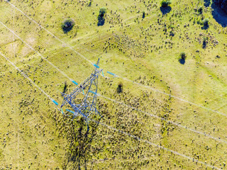 Aerial view of high voltage electricity towers, in the rural area.