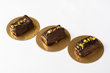 Candy in chocolate glaze on a golden substrate