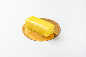 Candy in yellow glaze on a golden substrate