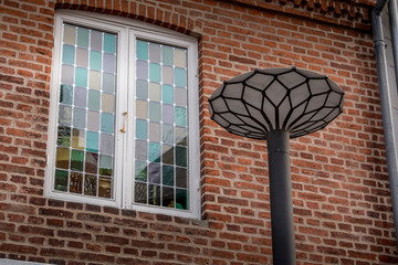 A beautiful window with many colors and a street lamp