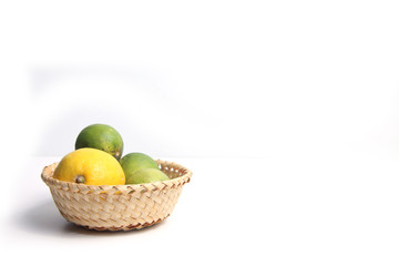 citrus fruits in a basket isolated on white background