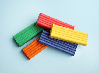 Fototapeta premium Multi-colored plasticine on blue background
