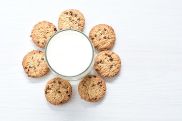Oatmeal cookies and chocolate chips on light background