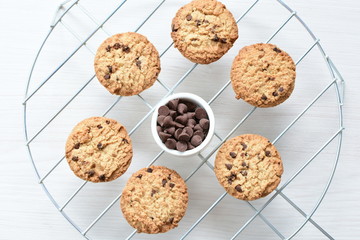 Oatmeal cookies and chocolate chips on light background