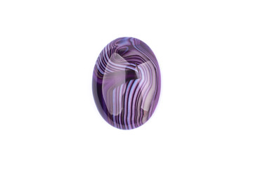 Oval cabochon stone of purple color on a white isolated background
