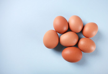 Fresh eggs on blue background