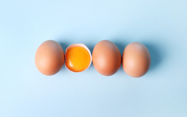 Fresh eggs on blue background