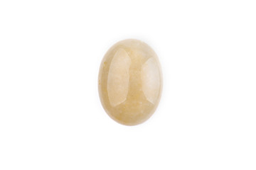 Oval yellow cabochon stone on a white isolated background