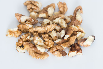 Unshelled walnuts pile isolated on white background, healthy eating concept