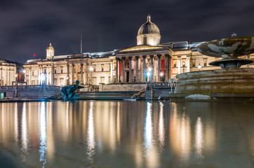 The National Gallery in London, night view over Trafalgar square fountains