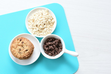 Oatmeal cookies and chocolate chips on colorful background