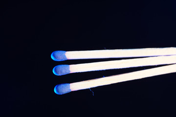 Lit matches and blown out in the studio photographed with colorful foils before the flashes