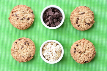 Oatmeal cookies and chocolate chips on colorful background