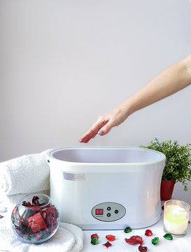 Hand paraffin therapy in a spa salon. Skin care.