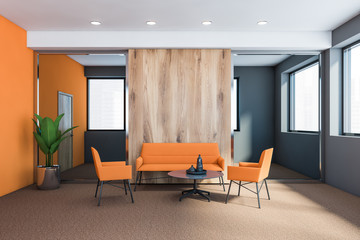 Grey and orange office waiting room with sofa