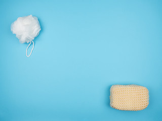 Two washcloths for bathing on a blue background.