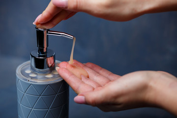 People use the soap dispenser of gray on a gray table