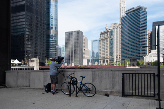 A Lone Cameraman Filming From Dearborn Street Bridge Towards The University Of Chicago And State Street Bridge