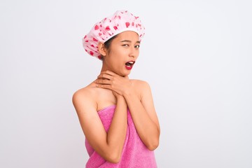 Young chinese woman wearing shower towel and cap bath over isolated white background shouting and suffocate because painful strangle. Health problem. Asphyxiate and suicide concept.