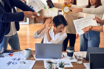 Group of business workers working together. Partners stressing one of them at the office