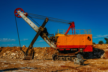 Fototapeta premium Excavator machine works in limestone pit quarry