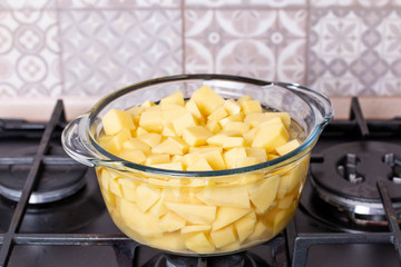 Boil cut potato in hot pot