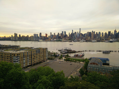 View of evening New York across the river. Manhattan at sunset. City center from a bird's eye view. Photo from the quadrocopter.