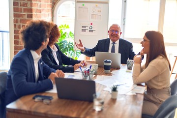 Group of business workers smiling happy and confident. Speaking with smile on face working together at the office.
