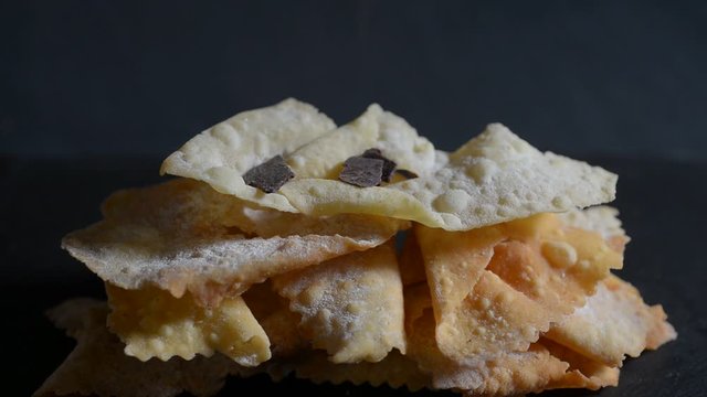 traditional carnival pastry on black background with chocolate chips