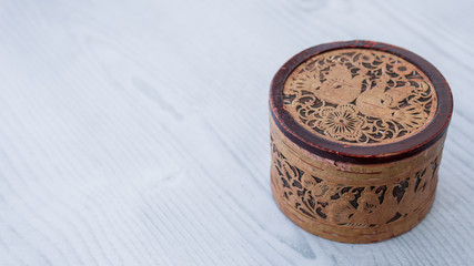 Old wooden jewerly box. Fashion brown trunk for bijoutery. Isolated on the white wooden background.
