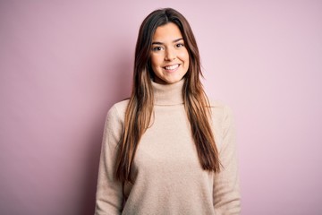 Fototapeta premium Young beautiful girl wearing casual turtleneck sweater standing over isolated pink background with a happy and cool smile on face. Lucky person.