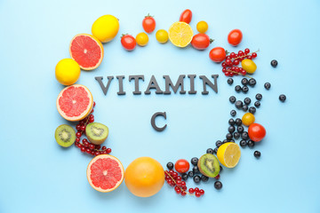 Healthy products rich in vitamin C on color background