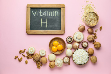 Healthy products rich in vitamin H on color background