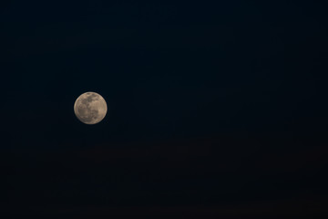Beautiful view of the full moon rising in the horizon