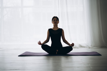 Young beautiful woman practicing yoga with mountain view in the background. Wellness concept. Calmness and relax, woman happiness. Toned picture